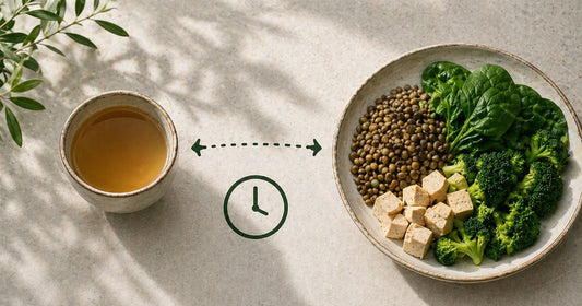 Tea placed separately from an iron-rich plant-based meal illustrating how timing affects iron absorption from food