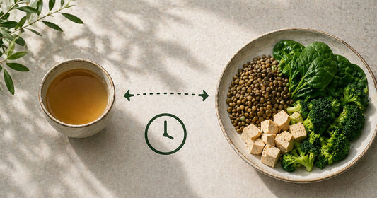 Tea placed separately from an iron-rich plant-based meal illustrating how timing affects iron absorption from food